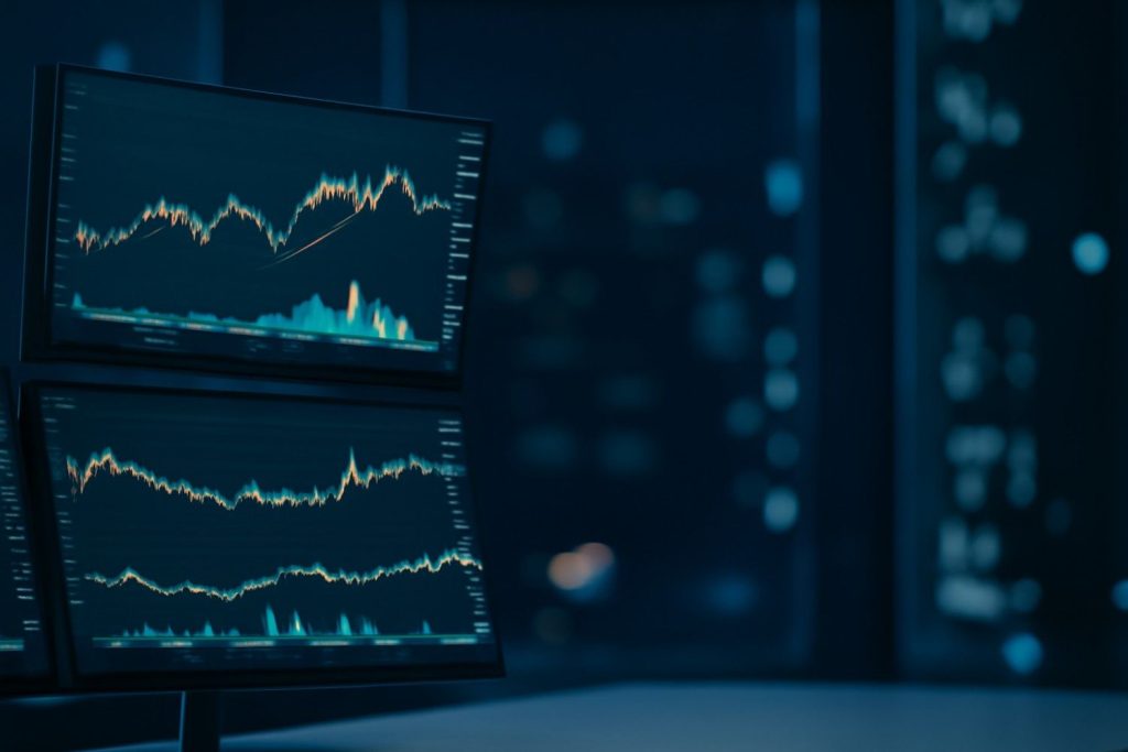 A focused trader analyzing charts on multiple monitors using a swing trading screener to filter profitable short-term stock opportunities